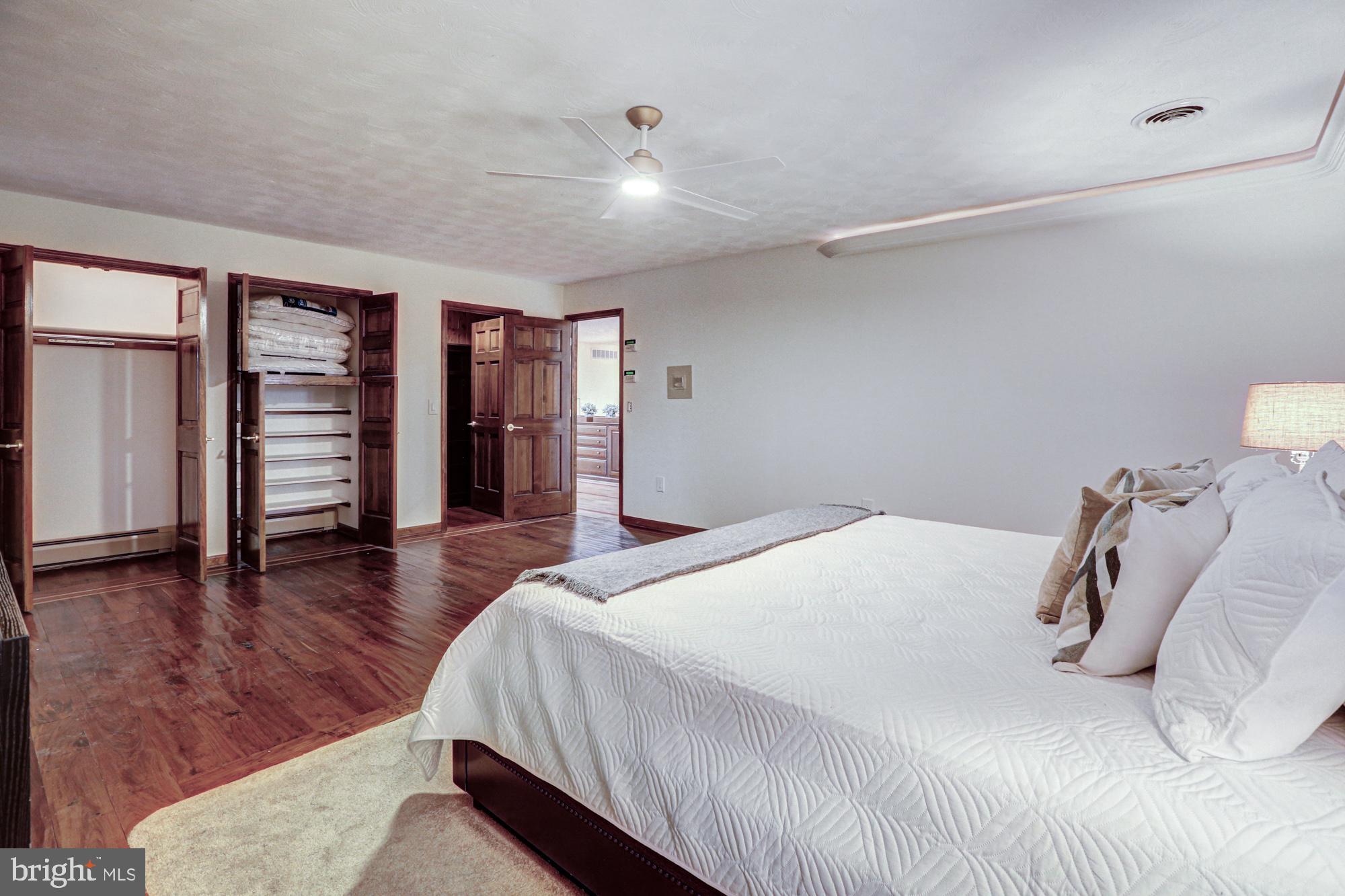 550 Green Giant Road Townsend, DE 19734 - Photo 68 of 145 a bedroom with a large bed and wooden floor