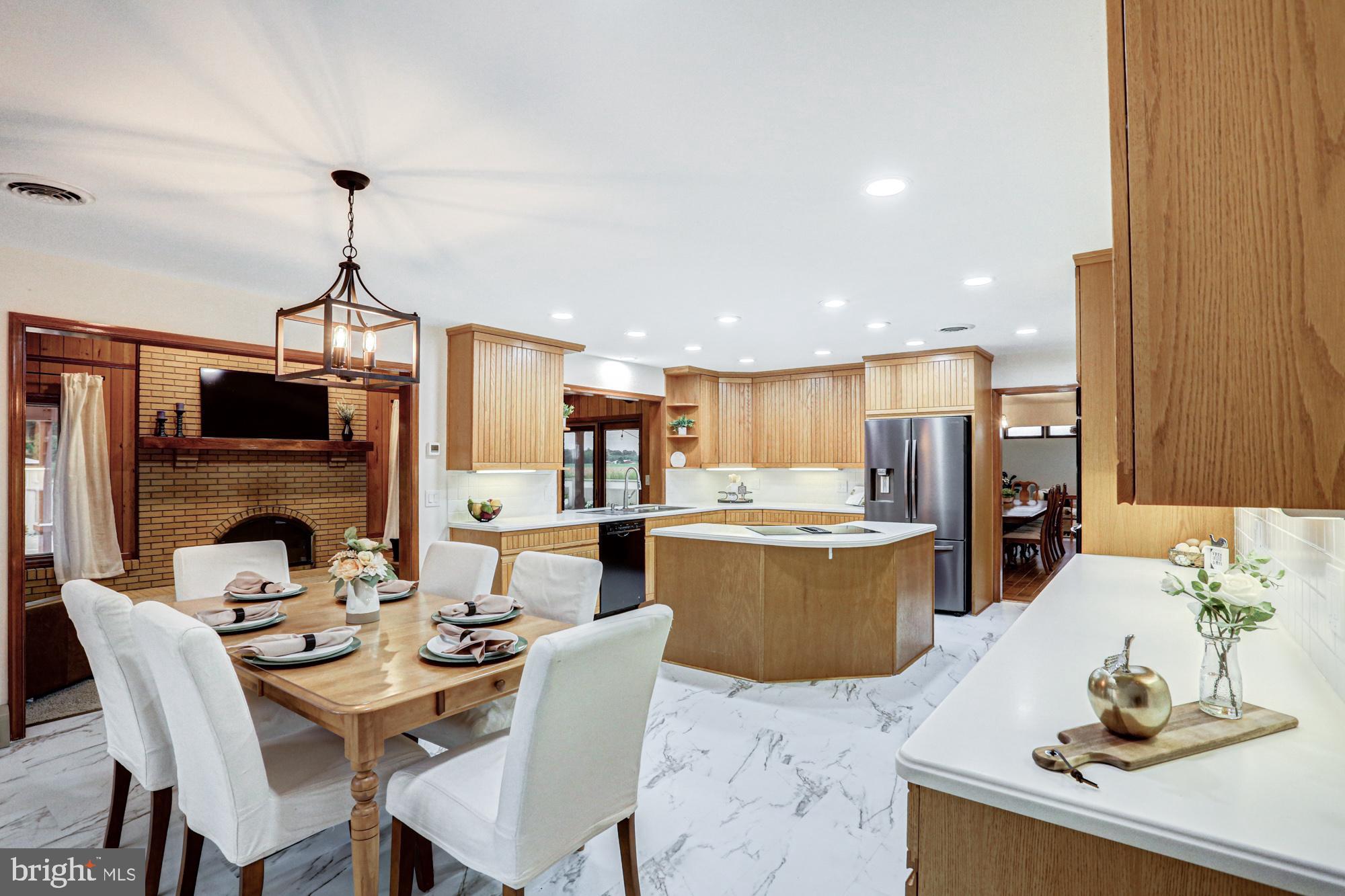 550 Green Giant Road Townsend, DE 19734 - Photo 81 of 145 a dining room with a table or chairs and a kitchen view