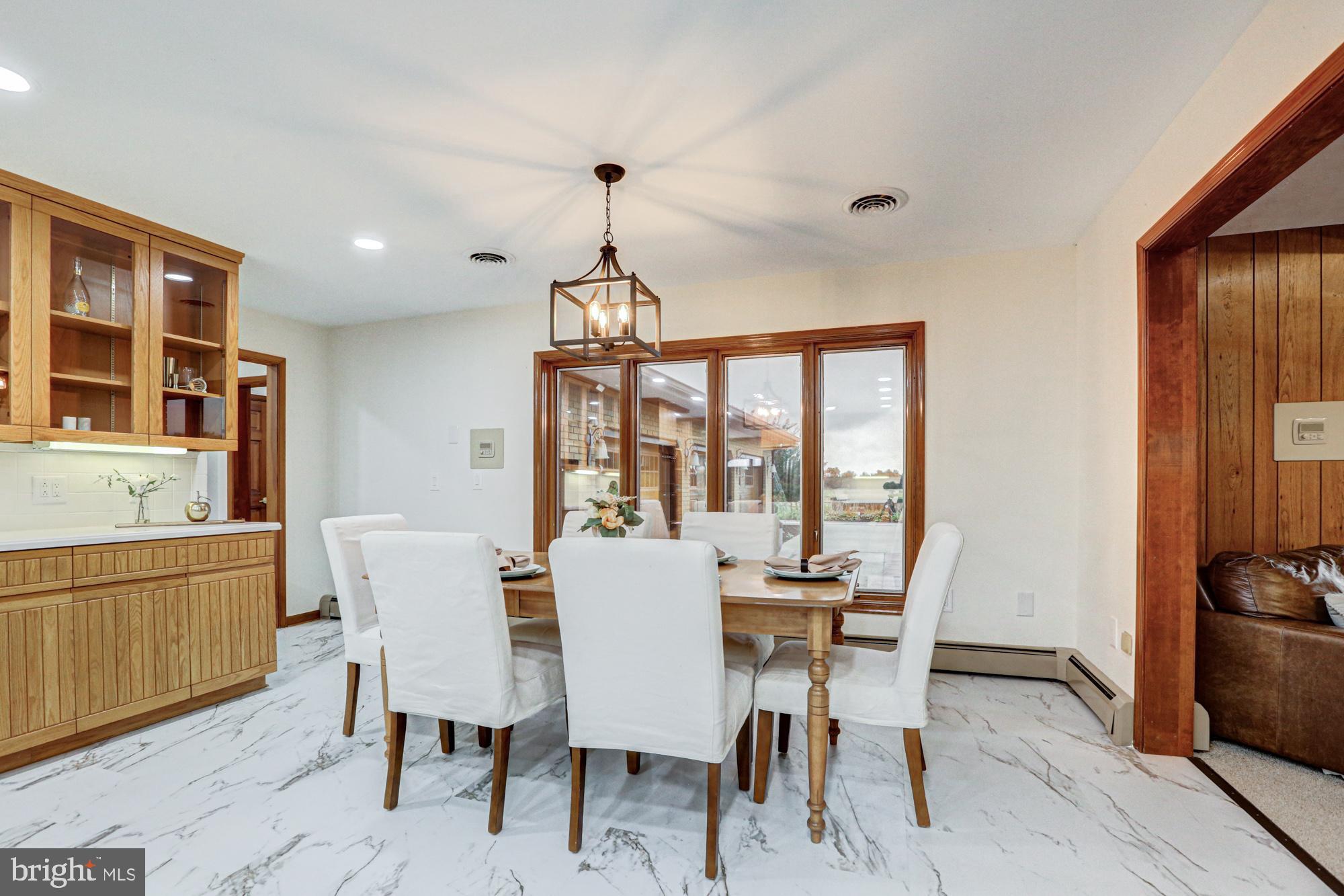 550 Green Giant Road Townsend, DE 19734 - Photo 86 of 145 a view of a dining room with furniture large window and wooden floor