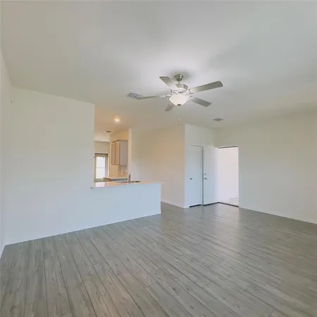 a view of an empty room with windows