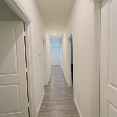 a view of hallway with wooden floor