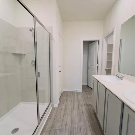 a bathroom with a sink and shower