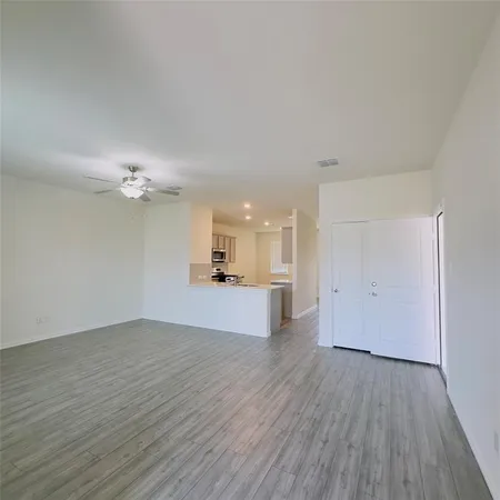 a view of a kitchen with wooden floor and a sink