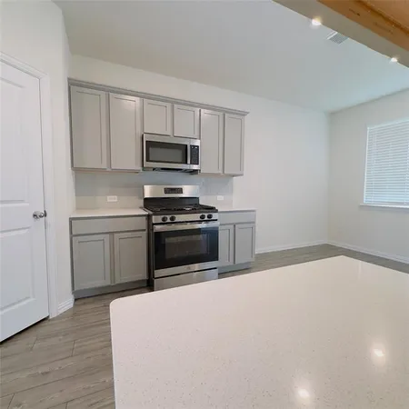 a kitchen with a sink and steel appliances