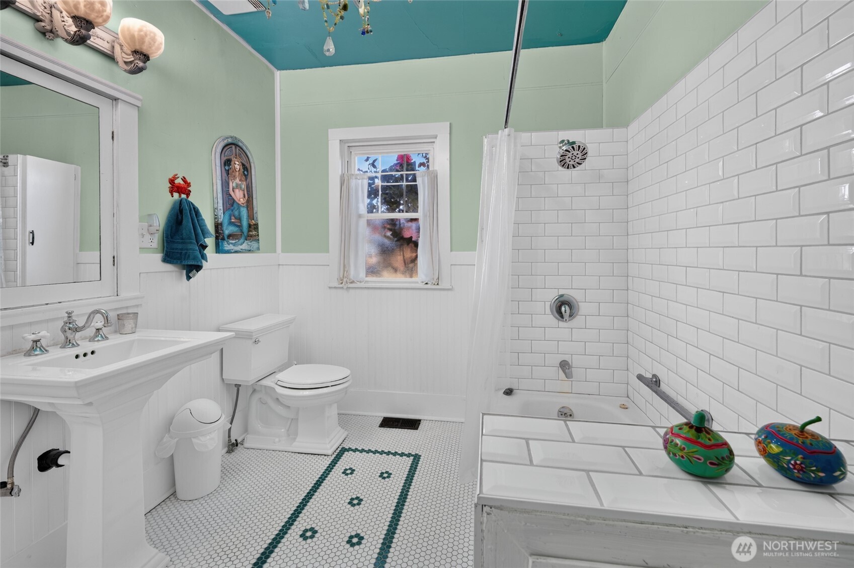 237 West 3rd Street Port Angeles, WA 98362 - Photo 19 of 40 a bathroom with a sink a toilet and shower