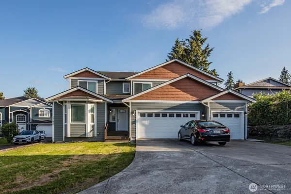 a car parked in front of house with a yard