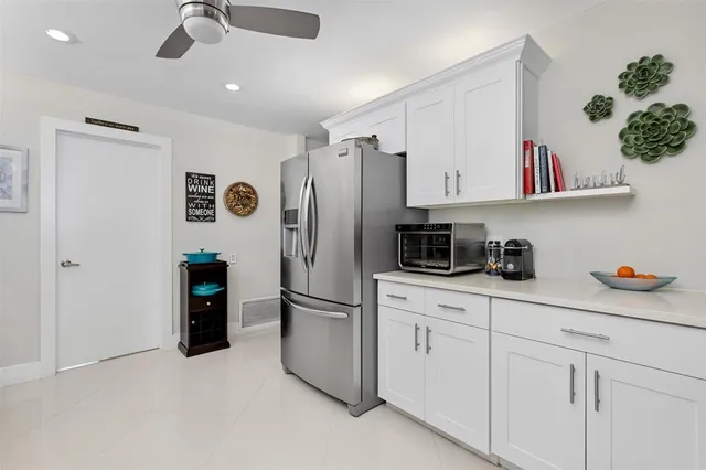 a kitchen with stainless steel appliances a refrigerator sink and cabinets