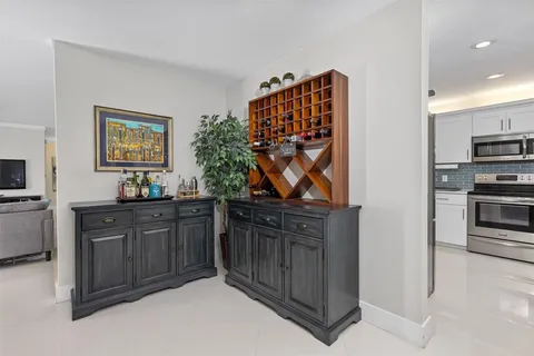 a kitchen with stainless steel appliances granite countertop a refrigerator and a stove