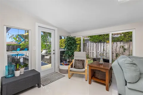 a living room with furniture and a floor to ceiling window