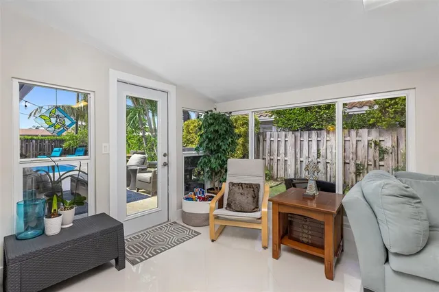a living room with furniture and a floor to ceiling window