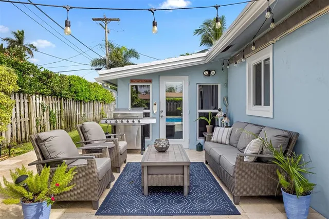 a view of a patio with couches chairs and a potted plant