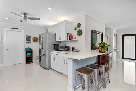 a living room with furniture and a kitchen view