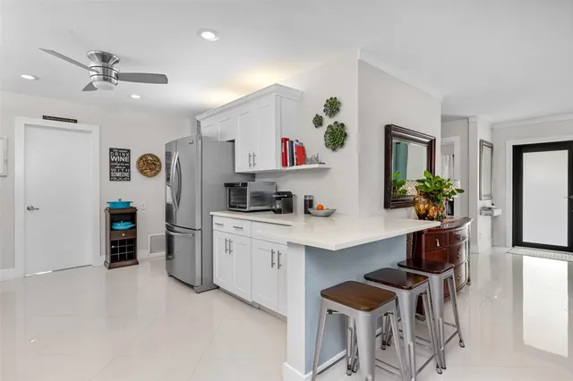 a living room with furniture and a kitchen view