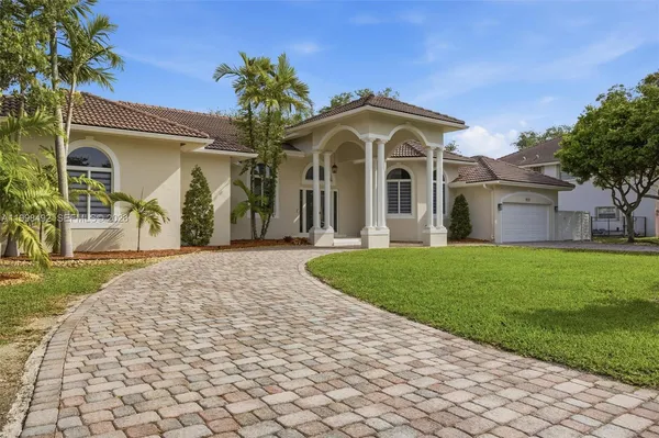 a front view of a house with a garden