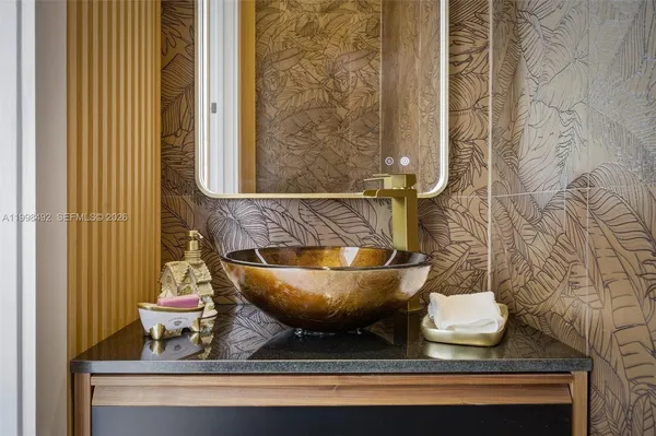 a bathroom with a sink and mirror