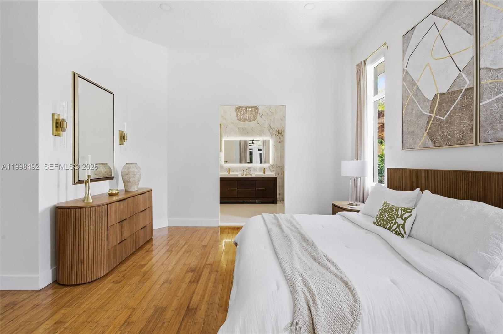 9717 Southwest 94th Terrace Miami, FL 33176 - Photo 25 of 63 a spacious bedroom with a bed and dresser with wooden floor