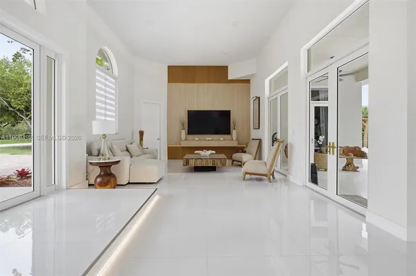 a kitchen with kitchen island granite countertop a sink a counter top space and living room view