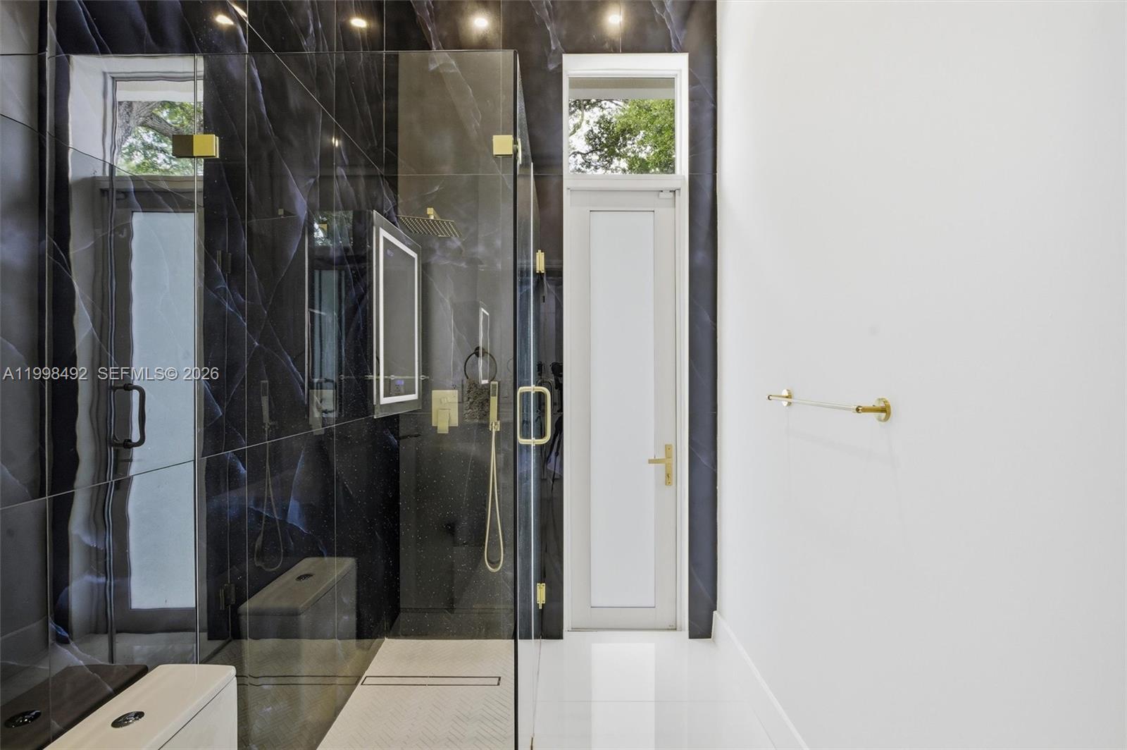 9717 Southwest 94th Terrace Miami, FL 33176 - Photo 38 of 63 a bathroom with a glass shower door