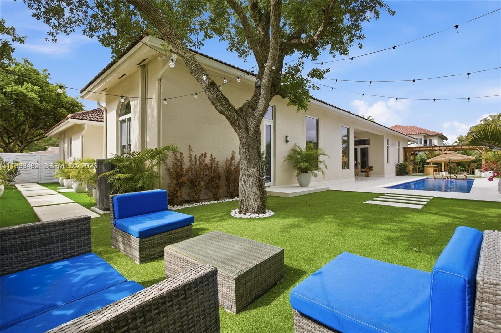 9717 Southwest 94th Terrace Miami, FL 33176 - Photo 49 of 63 a front view of a house with garden and sitting area
