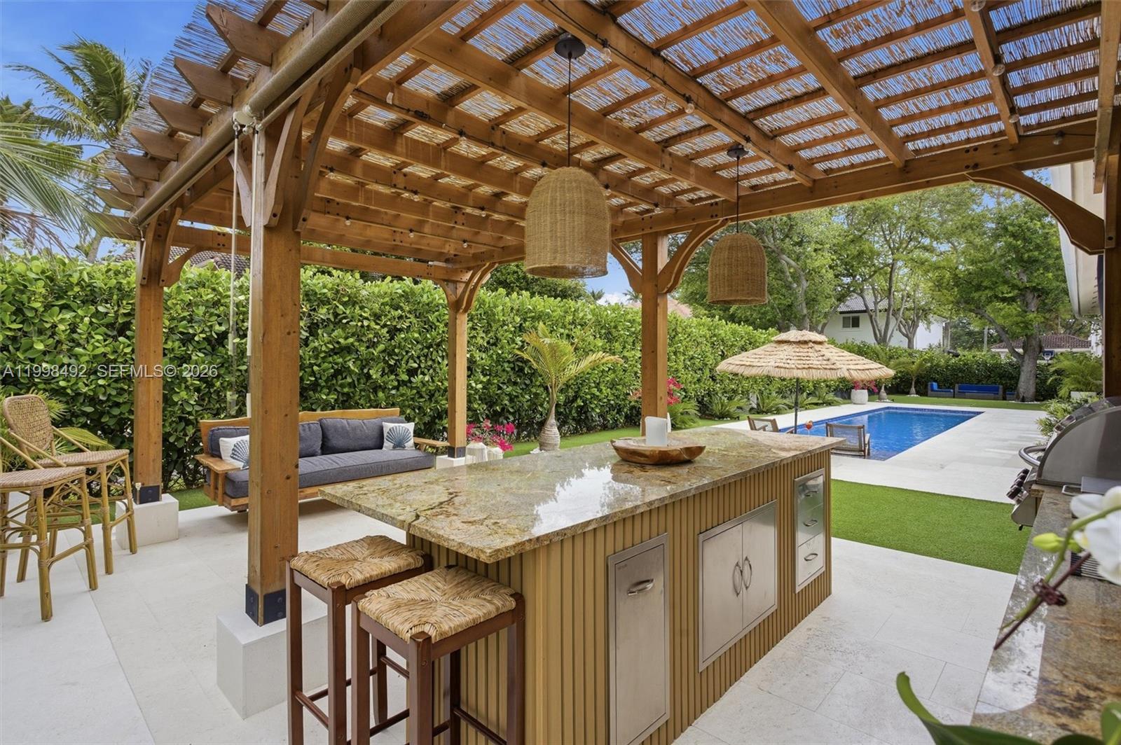 9717 Southwest 94th Terrace Miami, FL 33176 - Photo 57 of 63 a view of a patio with table and chairs potted plants and large tree