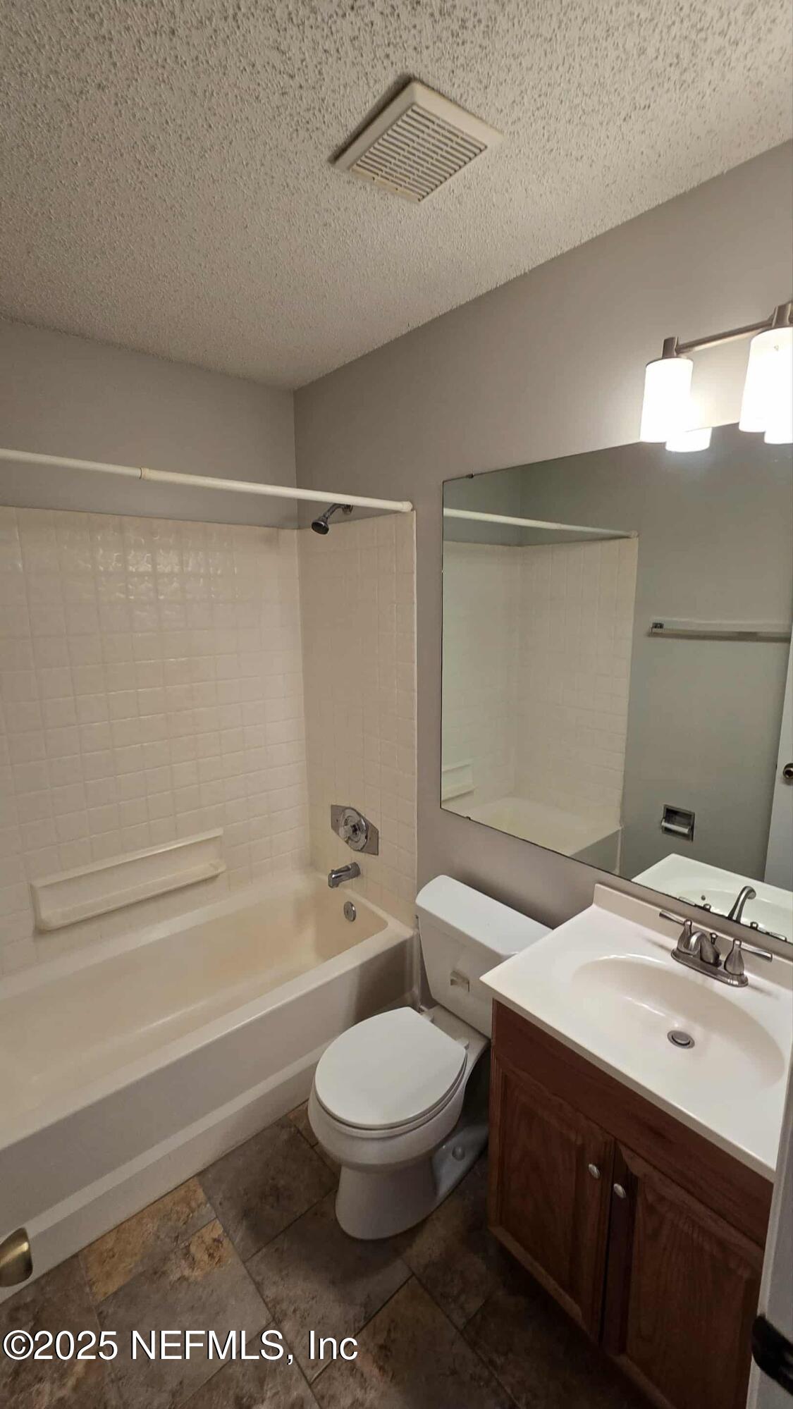 2302 East Challenger Court, Unit 2302 Jacksonville, FL 32233 - Photo 11 of 11 a bathroom with a sink a toilet and shower