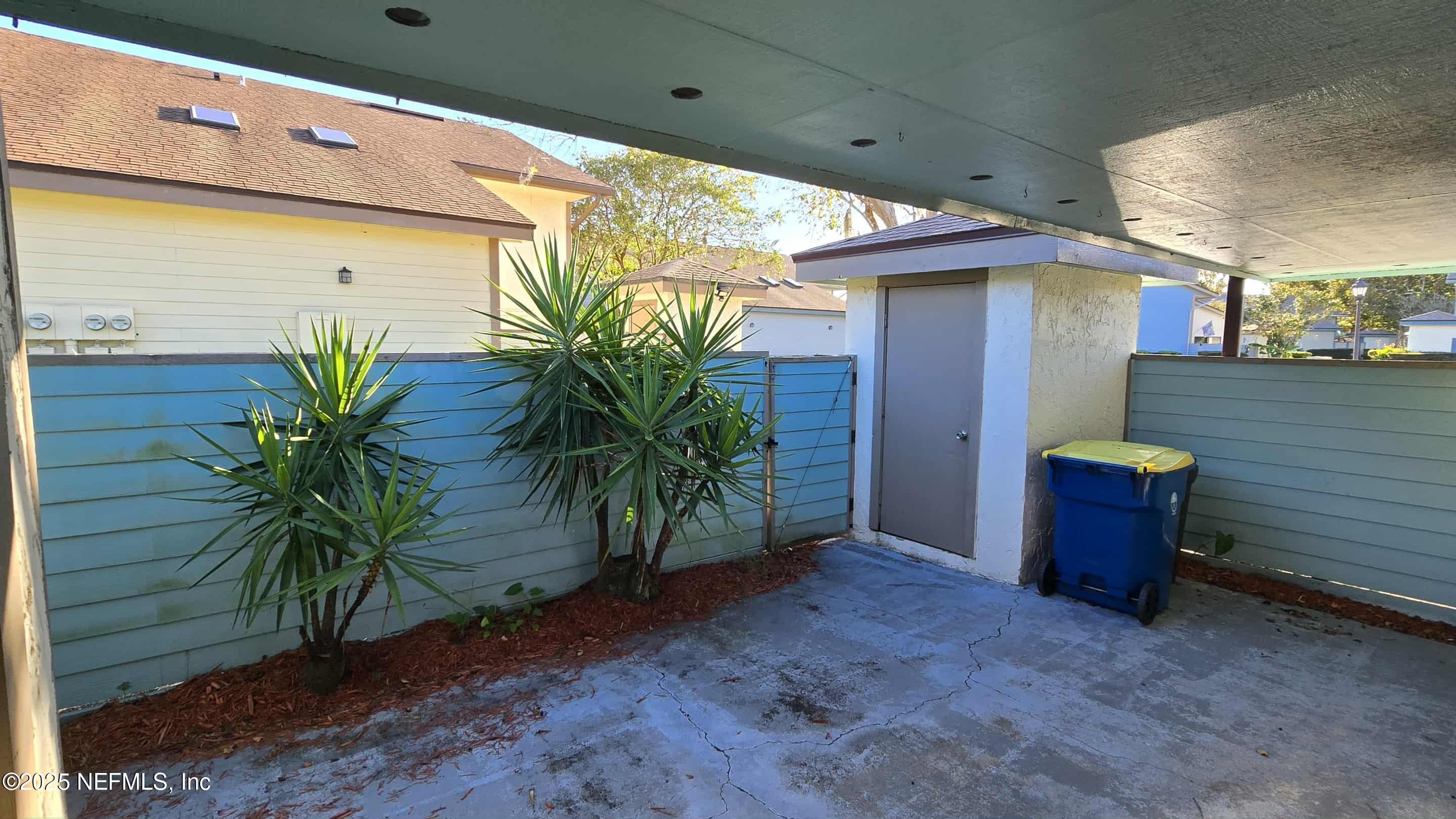 2302 East Challenger Court, Unit 2302 Jacksonville, FL 32233 - Photo 4 of 11 a backyard with potted plants