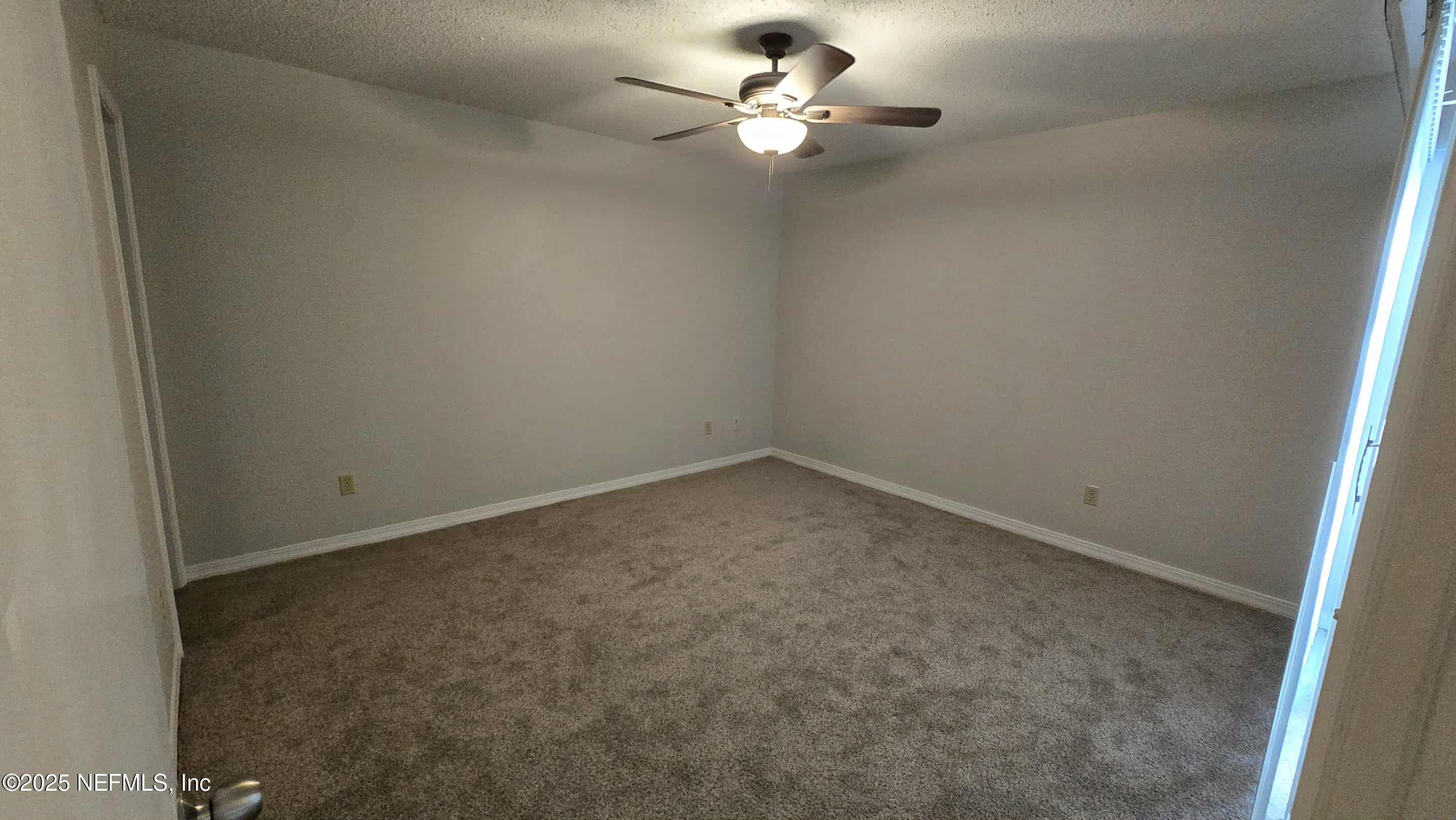 2302 East Challenger Court, Unit 2302 Jacksonville, FL 32233 - Photo 7 of 11 an empty room with a window