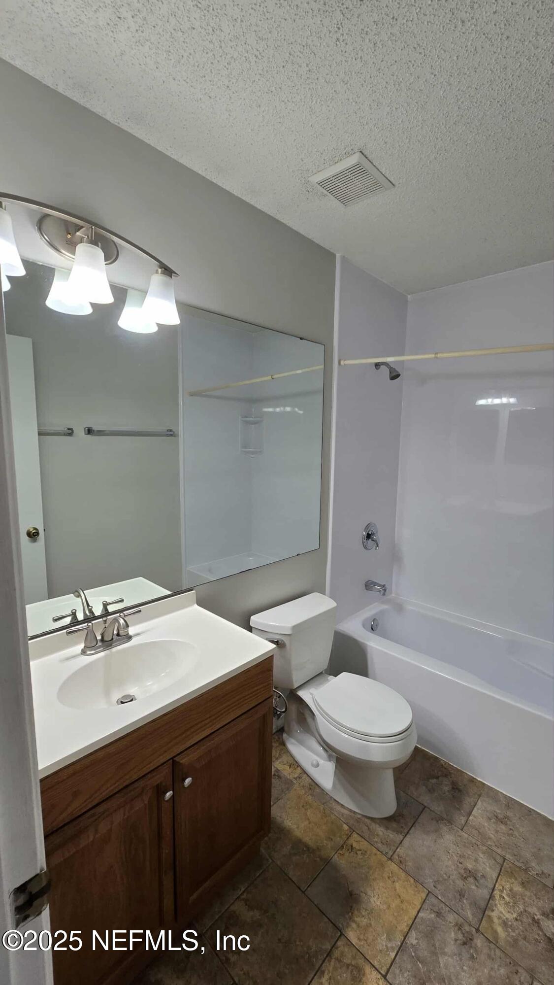 2302 East Challenger Court, Unit 2302 Jacksonville, FL 32233 - Photo 8 of 11 a bathroom with a sink toilet and shower