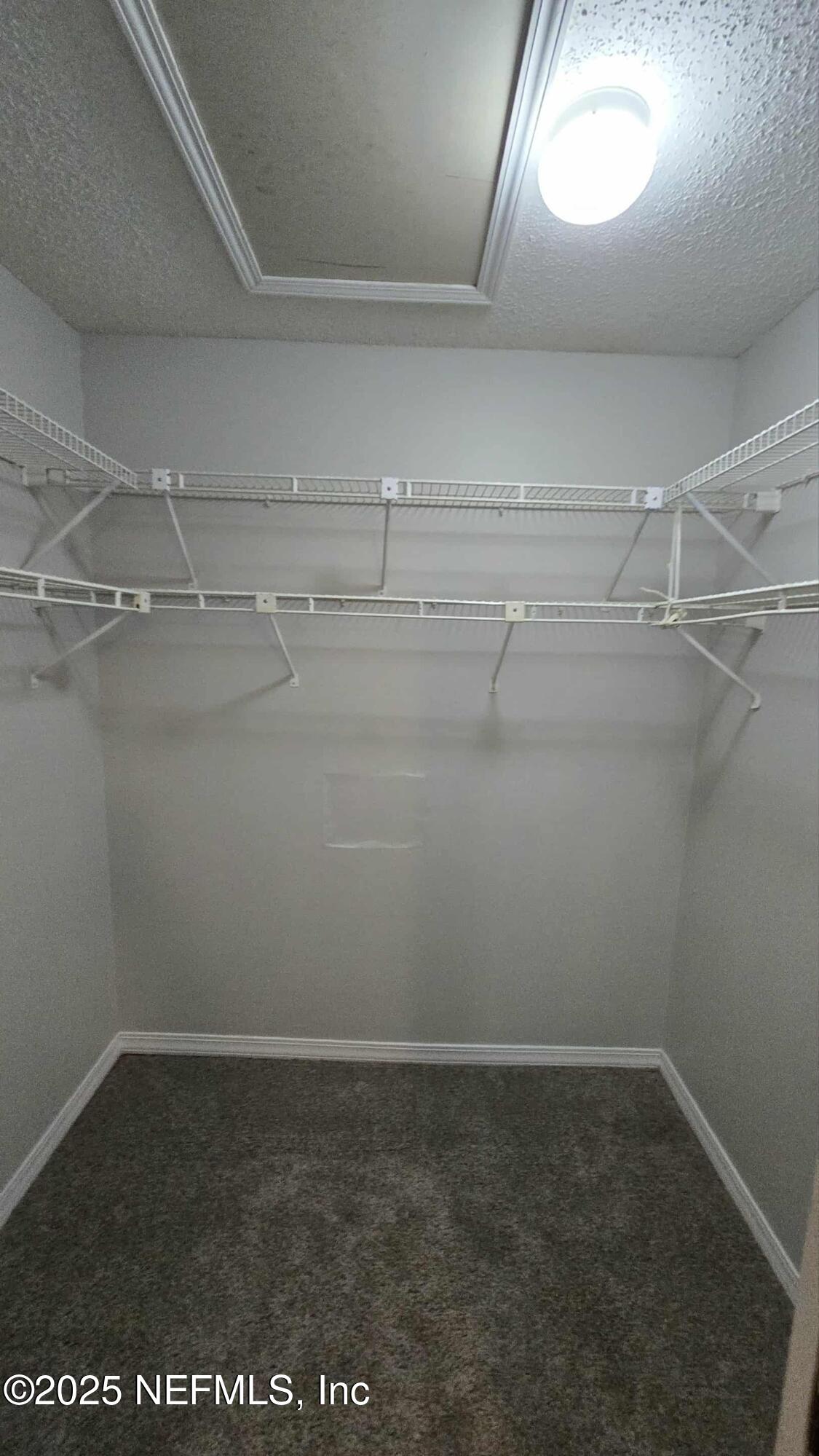 2302 East Challenger Court, Unit 2302 Jacksonville, FL 32233 - Photo 9 of 11 a view of a room with racks on the wall