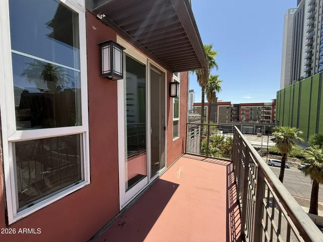 a balcony filled with a potted plant