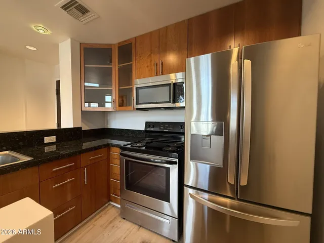 a kitchen with a refrigerator stove and microwave