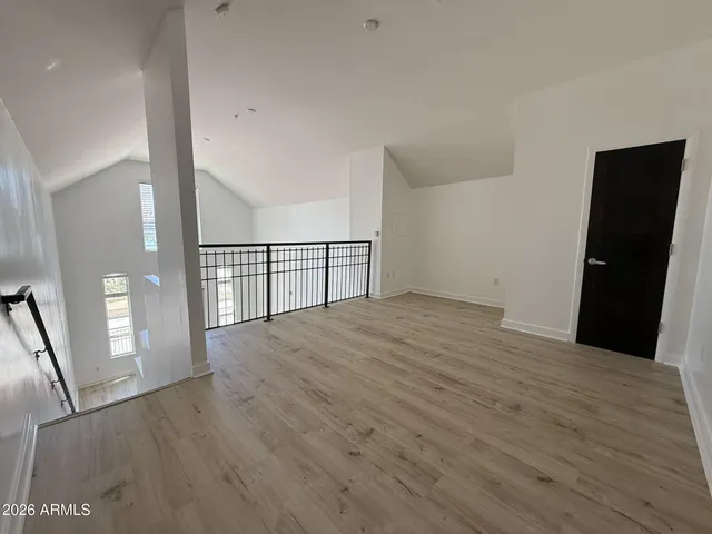 a view of empty room with wooden floor