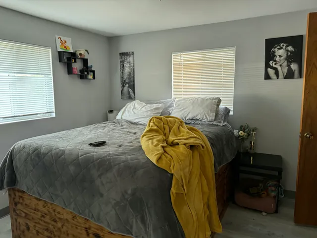 a bedroom with a bed and a window