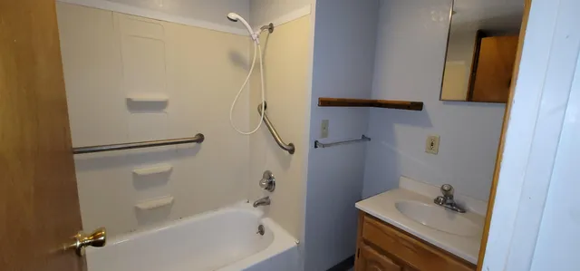 a bathroom with a bathtub and a sink