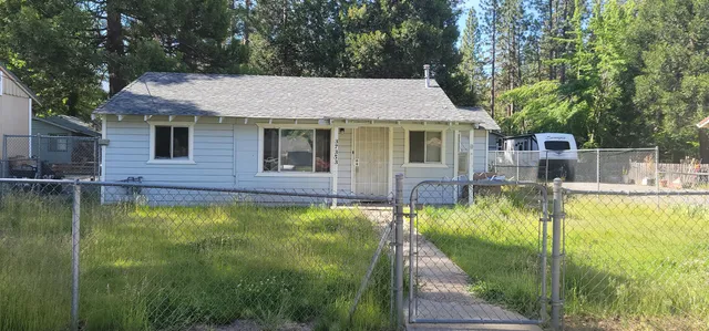 a view of a house with a yard balcony and swimming pool