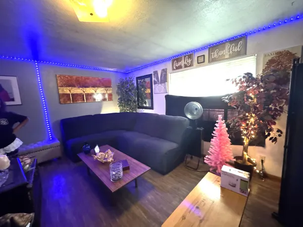 a living room with furniture and a chandelier