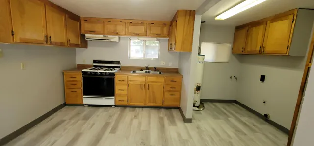 a view of a kitchen with a stove top oven