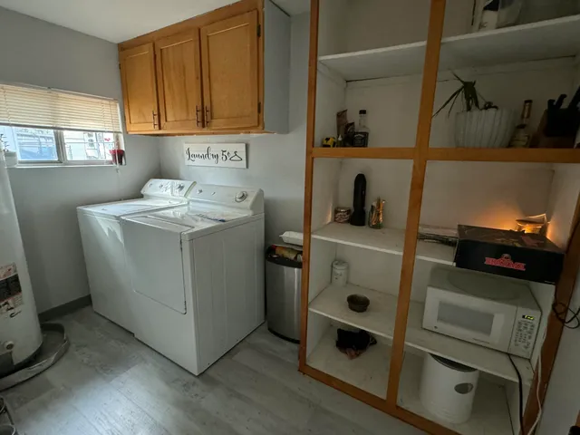 a utility room with sink dryer and washer