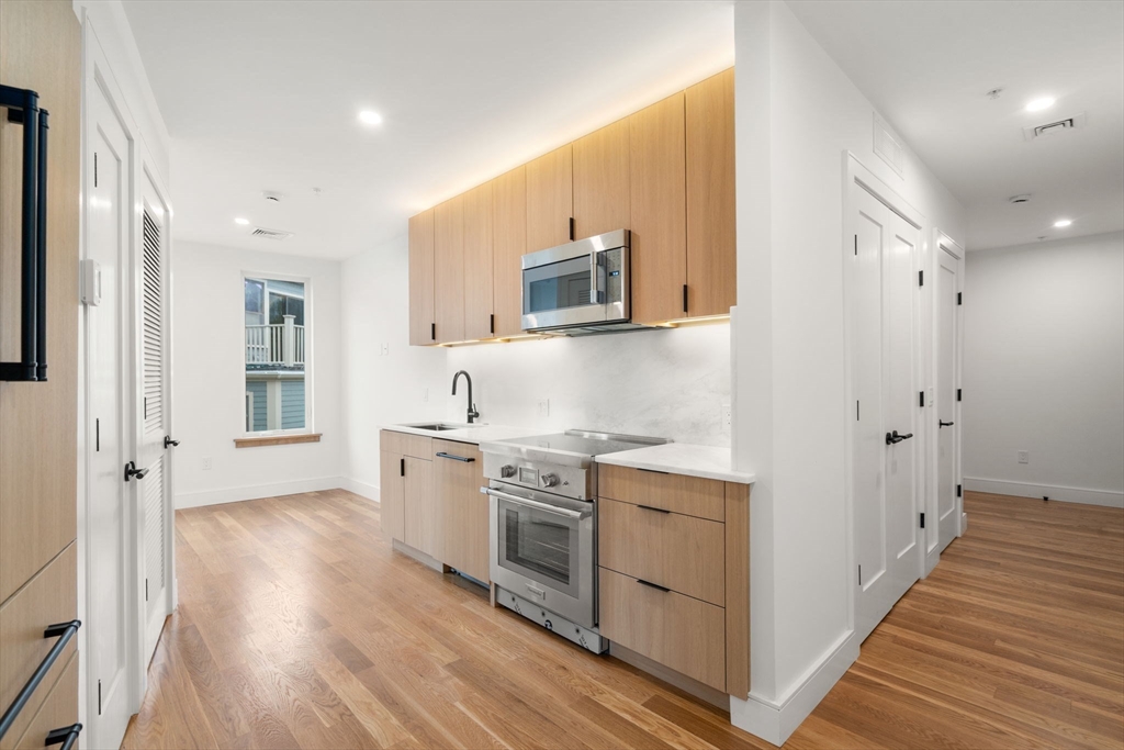 a kitchen with stainless steel appliances granite countertop a stove and a refrigerator