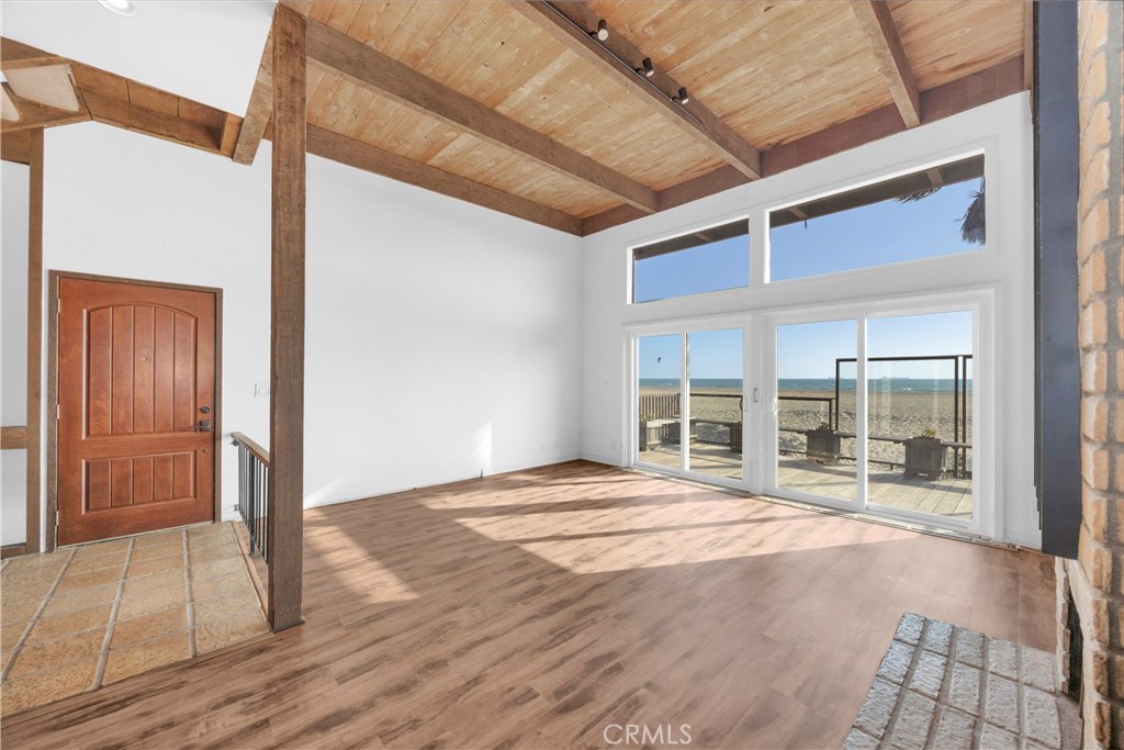 57 Surfside Avenue Surfside, CA 90743 - Photo 11 of 39 a view of an empty room with wooden floor and windows