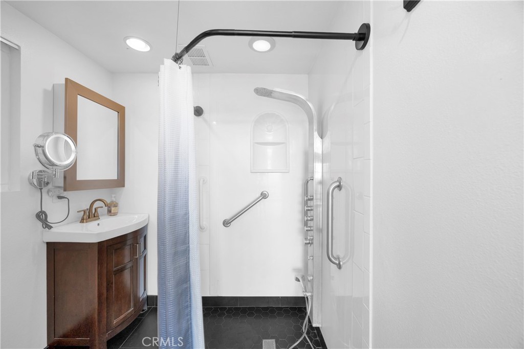57 Surfside Avenue Surfside, CA 90743 - Photo 23 of 39 a bathroom with a sink a mirror and shower