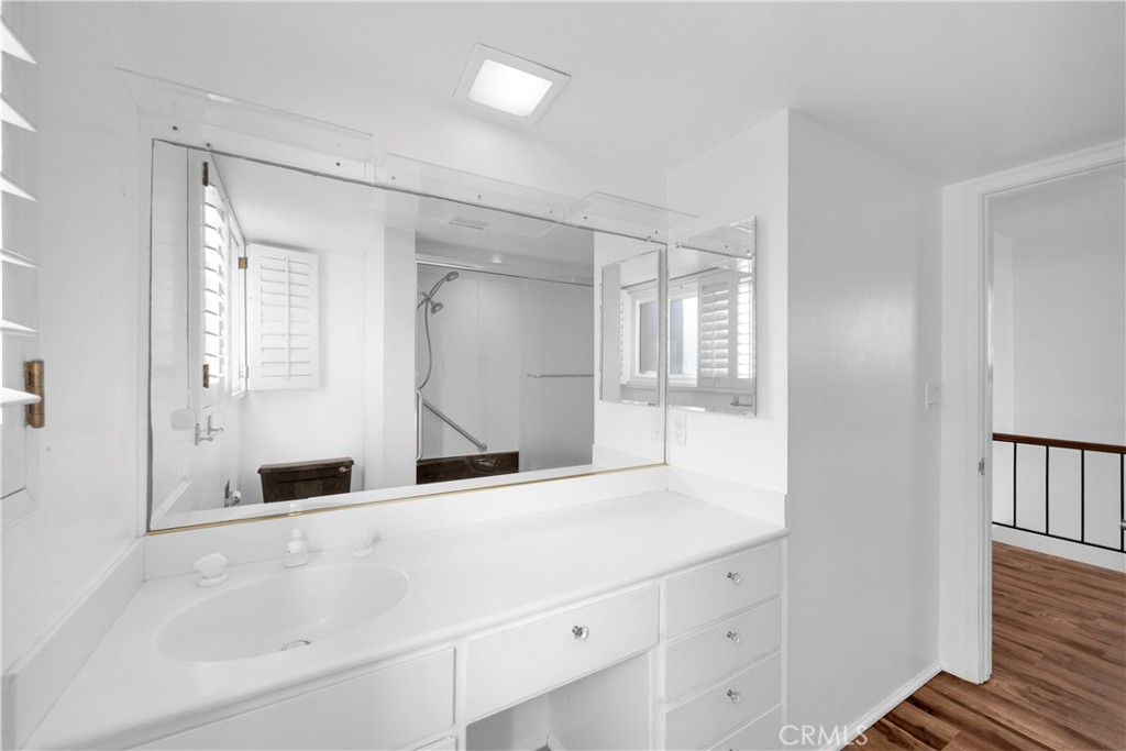 57 Surfside Avenue Surfside, CA 90743 - Photo 30 of 39 a bathroom with a shower sink and mirror