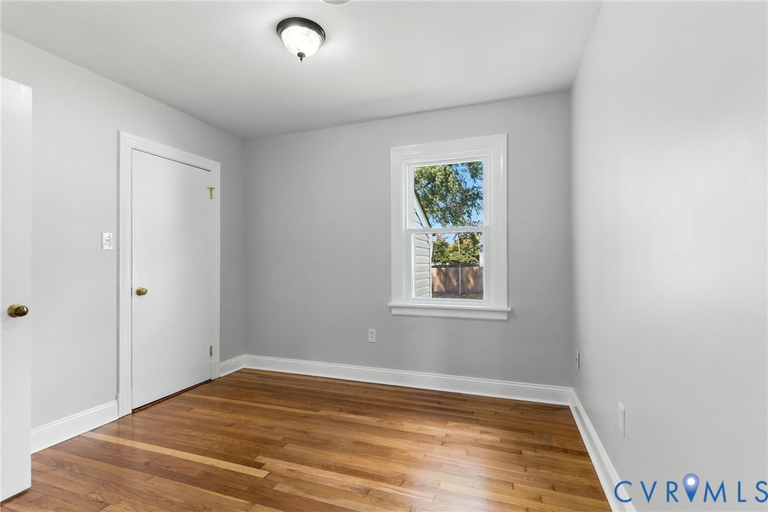 4825 Kinloch Lane Henrico, VA 23231 - Photo 20 of 28 a view of empty room with window and wooden floor
