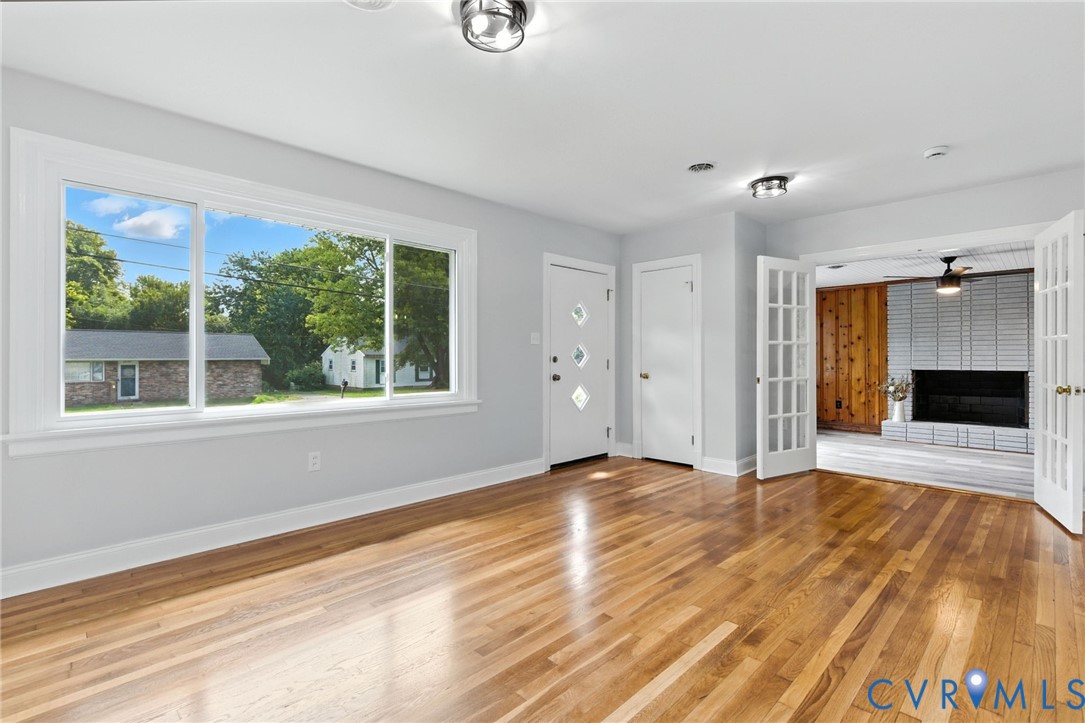 4825 Kinloch Lane Henrico, VA 23231 - Photo 6 of 28 a view of an empty room with a window and wooden floor