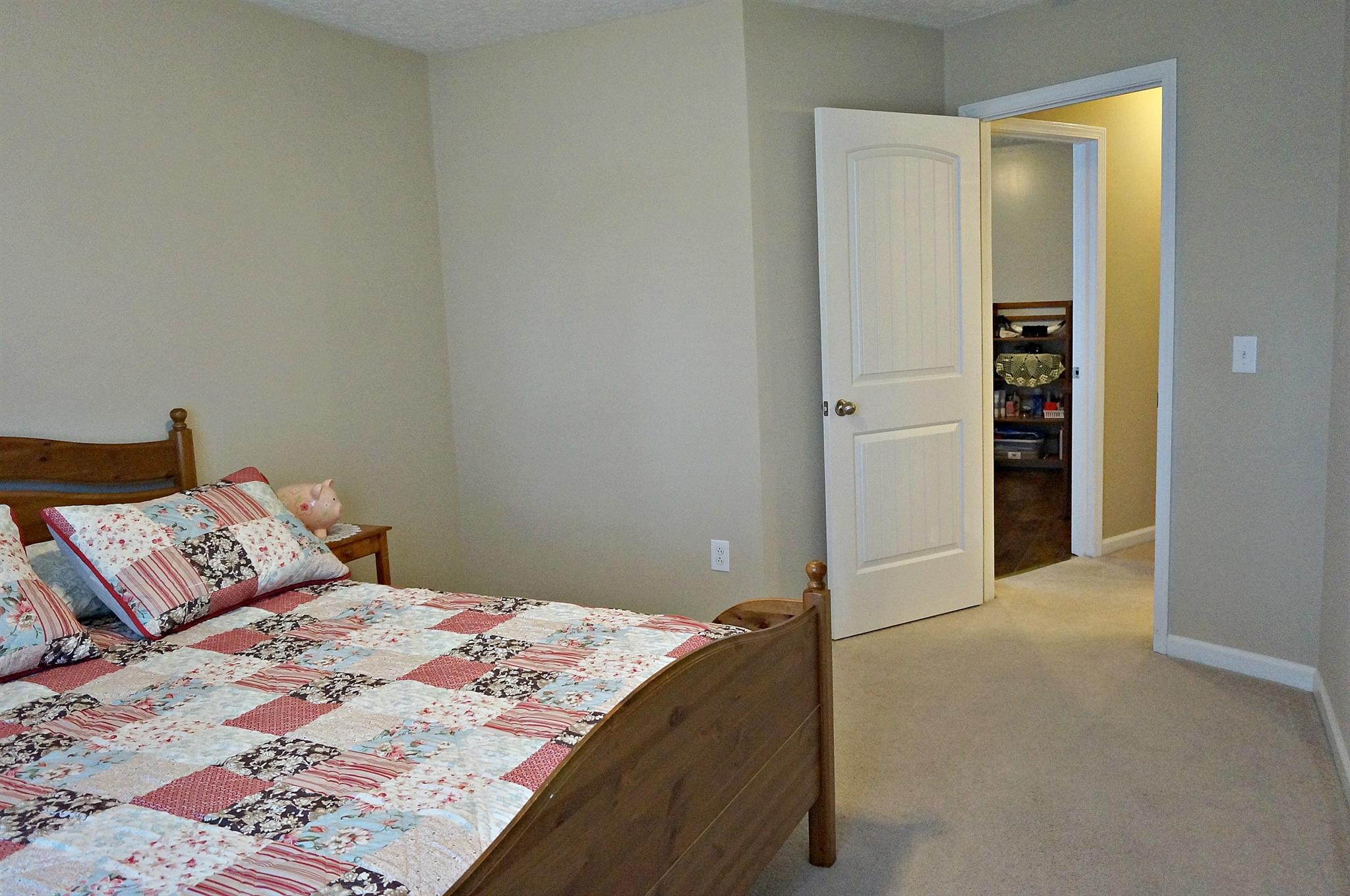 128 Filly Lane Springfield, TN 37172 - Photo 14 of 23 a bedroom with a bed and a walk in closet