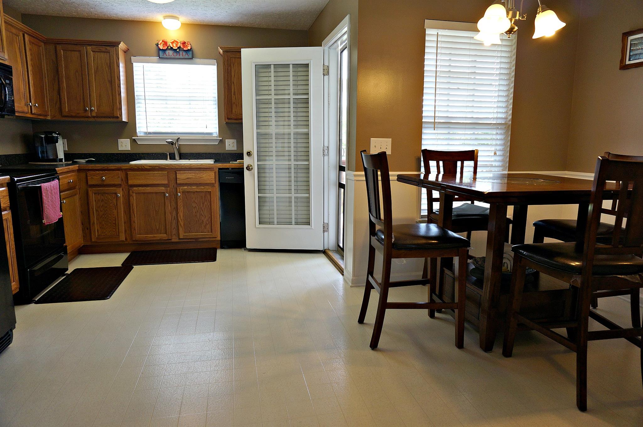 128 Filly Lane Springfield, TN 37172 - Photo 5 of 23 a kitchen with stainless steel appliances kitchen island granite countertop a table chairs sink and window