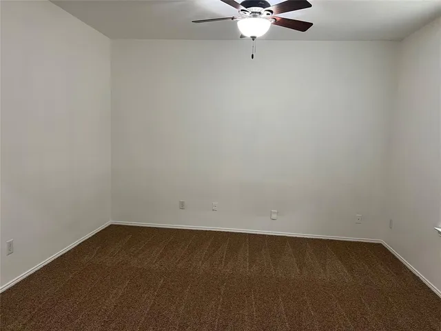 an empty room with a fan