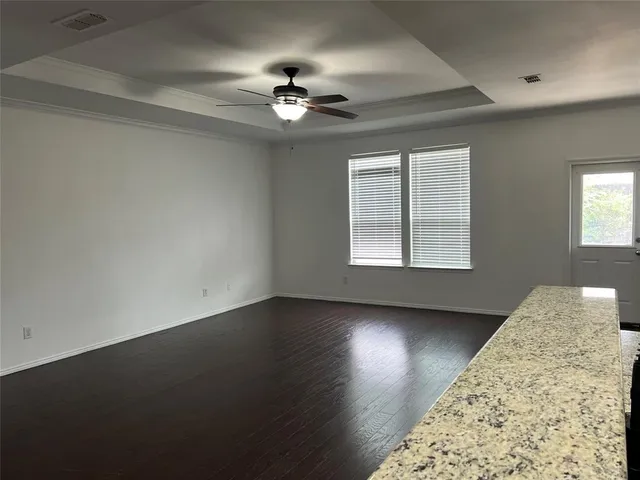 a view of a livingroom with a ceiling fan and window