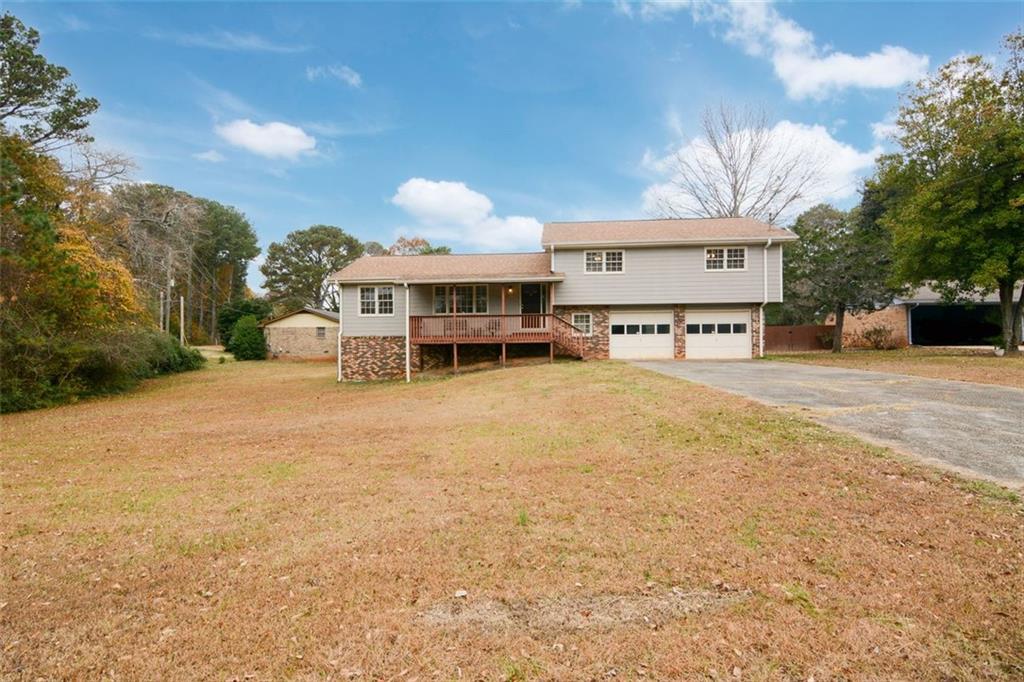 6007 Timber Ridge Court Stone Mountain, GA 30087 - Photo 1 of 1 a large house with a large tree in front of it