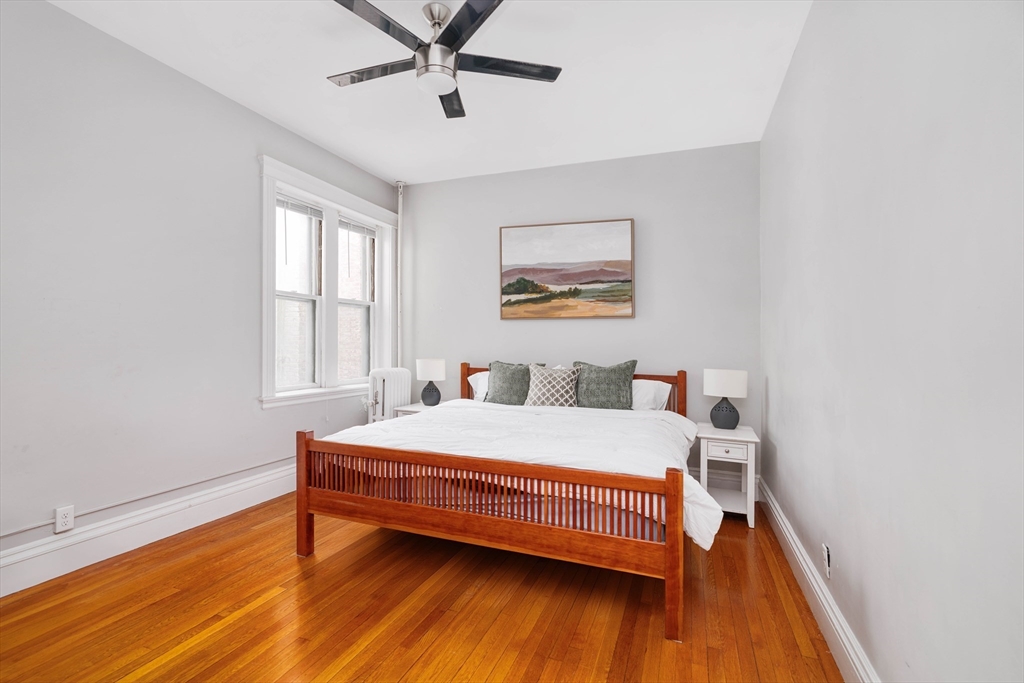 503 Boylston Street, Unit 4 Brookline, MA 02445 - Photo 8 of 16 a bedroom with a bed and wooden floor